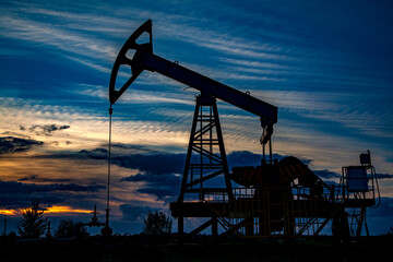 Oil and gas industry. Oil pump oil rig energy industrial machine for petroleum in the sunset...
