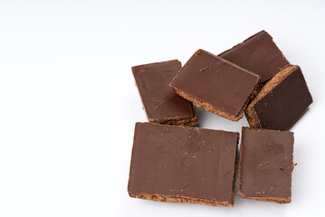 Pieces of closeup chocolate on a white background.
