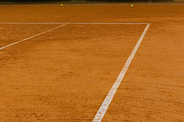 Corner of the ground tennis court with white lines