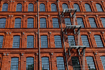 Front of the old textile factory building with an emergency exit.