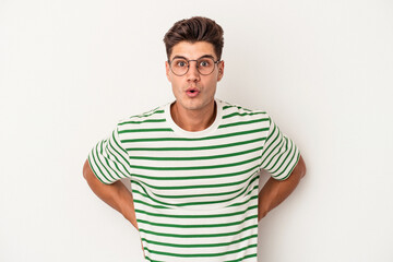 Obraz premium Young caucasian man isolated on white background being shocked because of something she has seen.