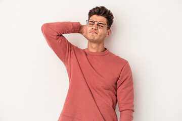 Young caucasian man isolated on white background massaging elbow, suffering after a bad movement.