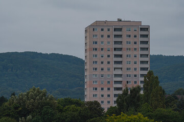 residential high-risewith a forest in the background and trees in the foreground 