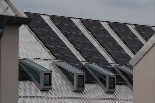 metallic windows on a top flor with a metallic sloping roof 