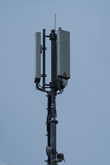 A Radio mast in an with a blue sky in the background