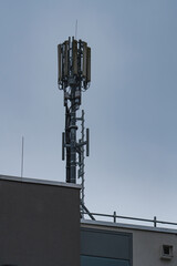 A Radio mast in an with a blue sky in the background