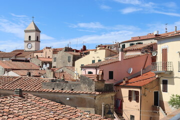 Elba, Italy – September 02, 2021: beautiful places from Elba Island. Aerial  view to the island. Little famous villages near the beaches. Summer tourist places. Clouds and blue sky in the background.