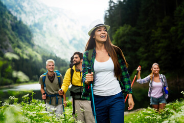 Group of friends hiking together outdoors exploring the wilderness and having fun