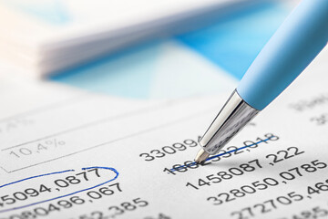 Accounting document with pen,color diagram and checking financial chart. Concept of banking, financial report and financial audit. In blue color.