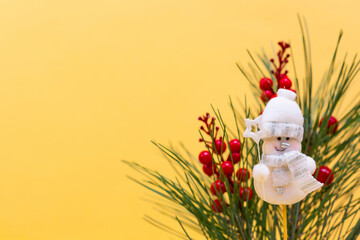 Happy new year background white snowman bauble made of wood with fir branches on a pastel background