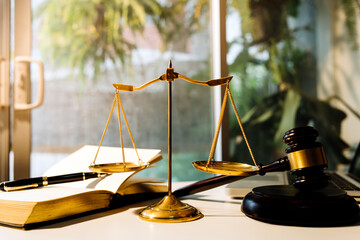 Business and lawyers discussing contract papers with brass scale on desk in office. Law, legal...