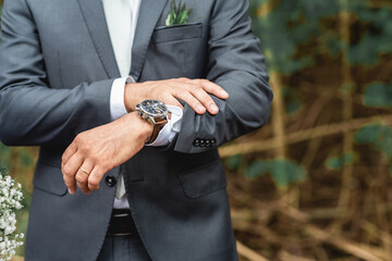 Groom Details awaiting his bride anxiously watching the time pass on his luxury watch