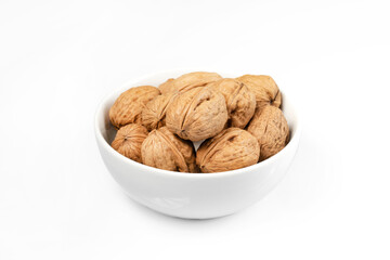walnuts, whole walnuts in white bowl on white background, 