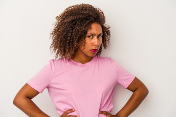 Young african american woman with curly hair isolated on white background frowning face in...