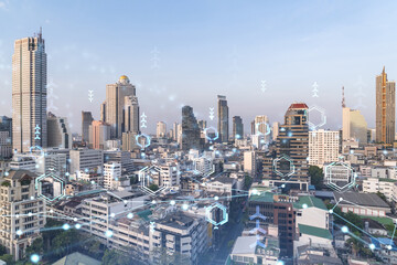 Fototapeta na wymiar Technology hologram over panorama city view of Bangkok. The largest tech hub in Southeast Asia. The concept of developing coding and high-tech science. Double exposure.