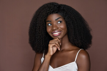 Gorgeous happy playful unusual beautiful young African American girl looking up touching face...