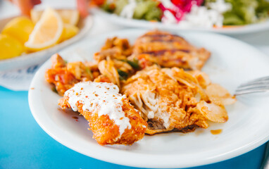 Mediterranean food concept. Fried fish on the white plate.