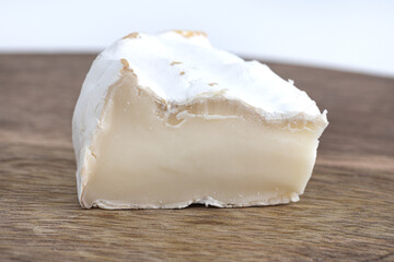 Camembert on a wooden board. Camembert cheese on a board close-up.