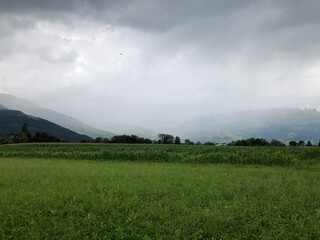 SCHAAN, LIECHTENSTEIN, AUGUST 3, 2021 Bad weather over a green field