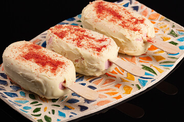 White chocolate eskimo cheese cake with banana and strawberry on black background