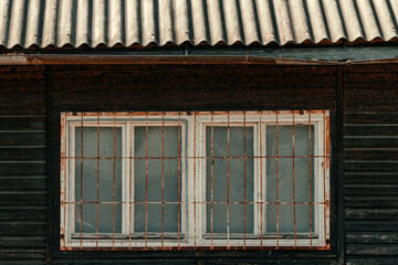 Fototapeta na wymiar Old worn prefabricated wooden house detail