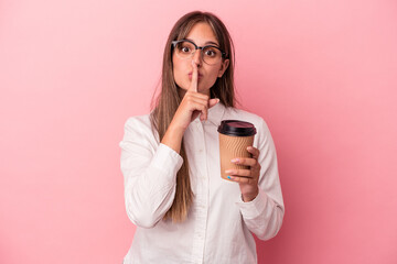 Young business caucasian woman holding a take away isolated on pink background keeping a secret or...