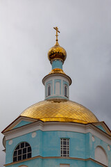 Fototapeta na wymiar Gilded main dome of the Vvedenskaya Russian Orthodox Church in the city of Kashira, Russia