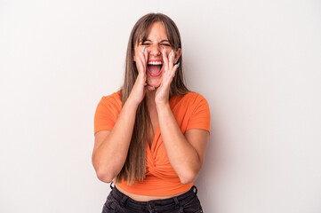 Young caucasian woman isolated on white background shouting excited to front.