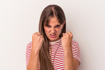 Young caucasian woman isolated on white background upset screaming with tense hands.
