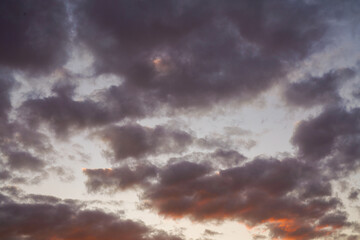 Naklejka na ściany i meble yellow and orange clouds at sunset. dramatic sky skyline background 