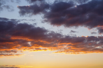 Fototapeta na wymiar yellow and orange clouds at sunset. dramatic sky skyline background 