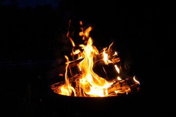 A bonfire burns in the dark of the night.