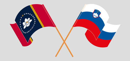 Crossed and waving flags of The State of Mississippi and Slovenia