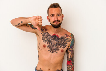 Young caucasian man without t-shirt isolated on white background  showing a dislike gesture, thumbs...