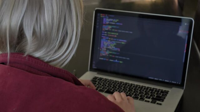 Woman developer working with computer at home office