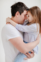 little daughter cuddling and having fun with dad. Happy family. 