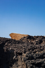 Fototapeta na wymiar View of the lava rock of Linosa