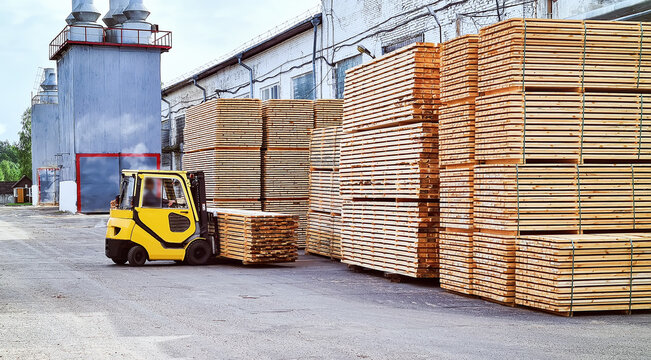 Forklift Loads Lumber Into Stacks At The Finished Product Warehouse