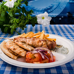 Greek souvlaki with pita bread and vegetables close-up on the table