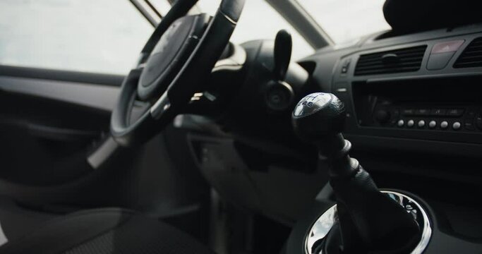 Female driver sit key start car put mask on gearshift lever and drive