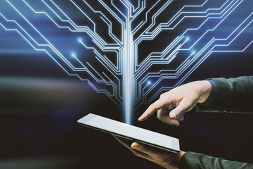 Close up of hand pointing at tablet with abstract circuit tree on dark blue background. Future, technology and communication concept.