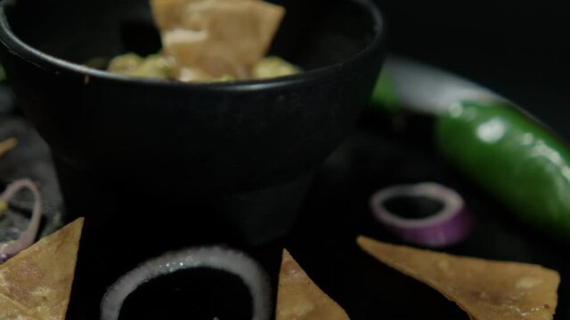 Tortilla chips, chili peppers, and onion slices on Mexican comal