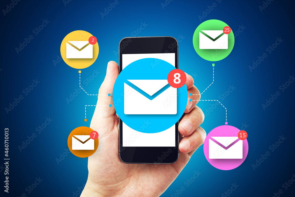 Poster close up of businessman hand holding smartphone with abstract email network on blue wall background.