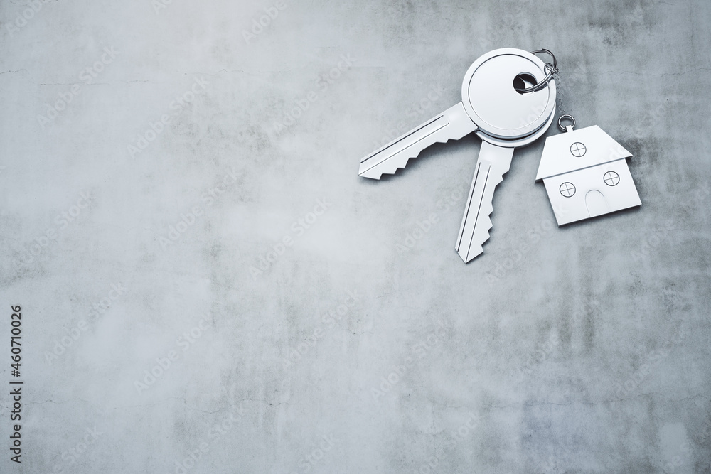 Poster close up of keys with house keychain on concrete surface background with mock up place. real estate 