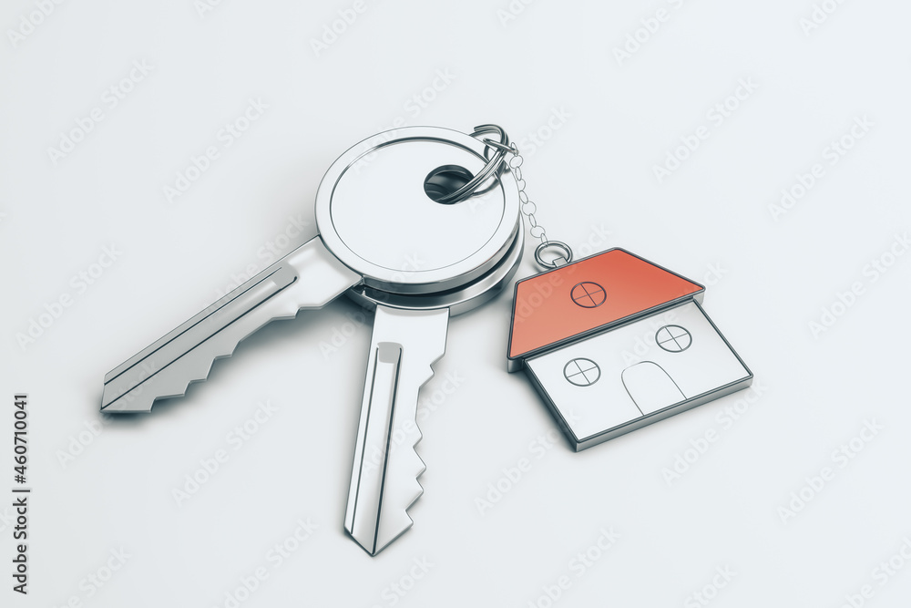 Poster close up of keys with house keychain on white desktop background. real estate and property concept. 