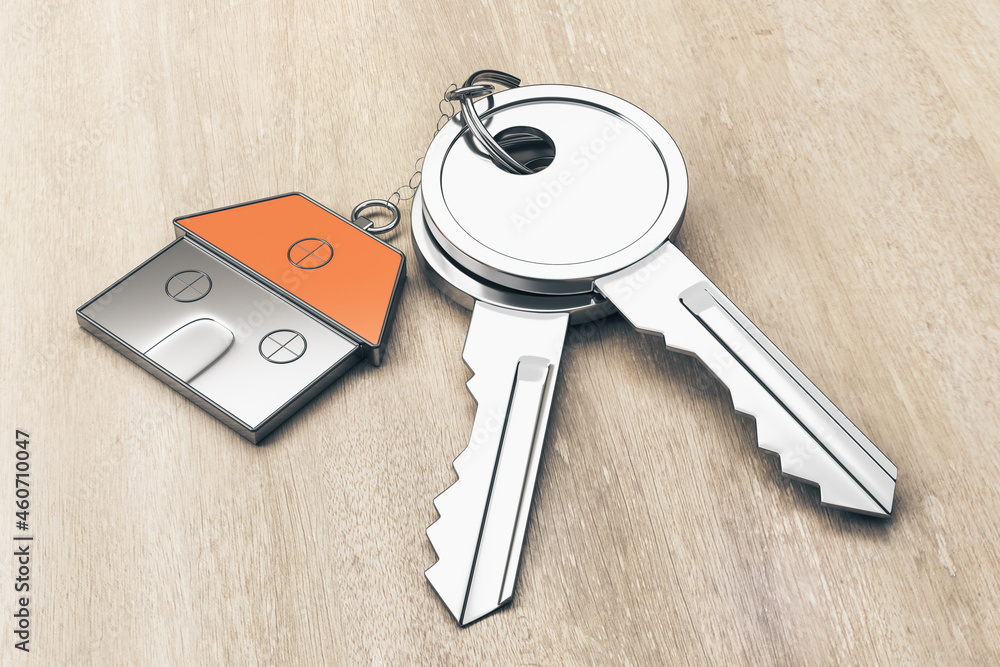 Poster close up of keys with house keychain on wooden table background. real estate and property concept. 3