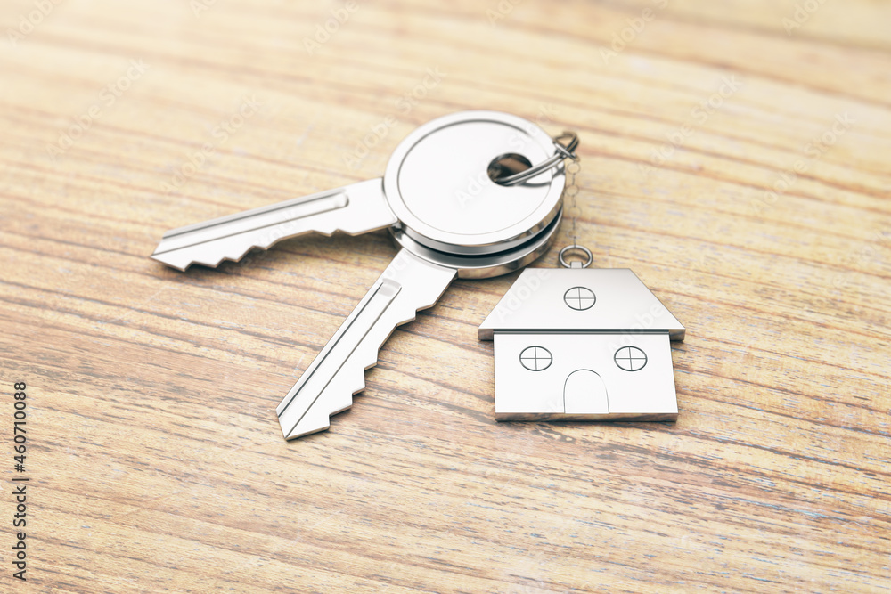Poster Close up of keys with house keychain on wooden surface background. Real estate and property concept. 3D Rendering.