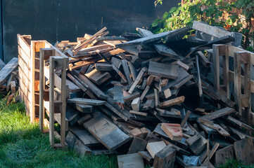 a pile of wooden planks lying on the grass
