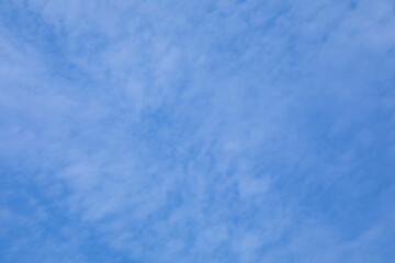 background of blue autumn sky with small white clouds