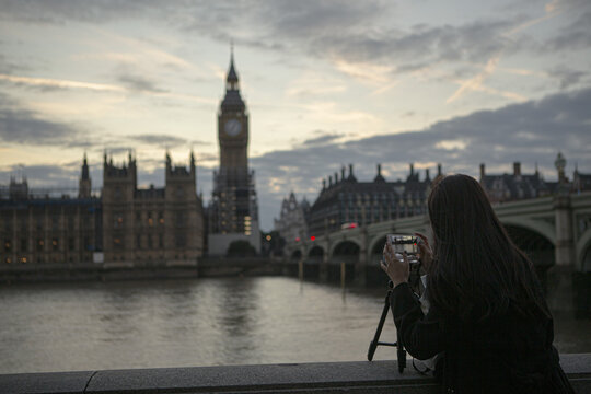 Big ben, across river, woman taking picture